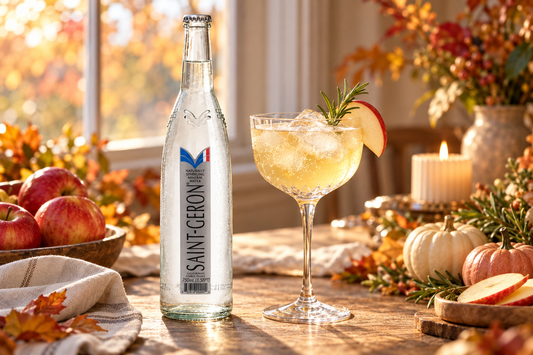 Saint-Géron mineral water beside an apple and rosemary mocktail on a cozy autumn table.