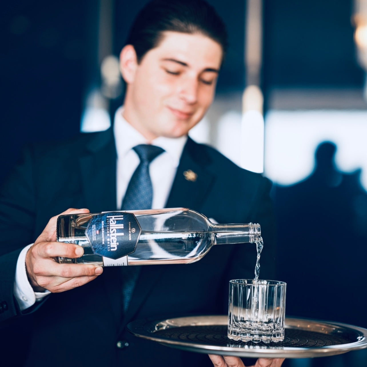 Waiter pouring Halibut vodka into a glass