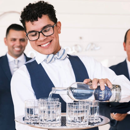 Waiter pouring Hallstein Water at a private event